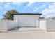 Garage exterior with a white garage door, white fence, and concrete driveway at 711 42Nd S Ave, St Petersburg, FL 33705
