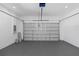 Clean, gray-floored garage with a closed, gray garage door at 711 42Nd S Ave, St Petersburg, FL 33705