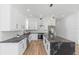 Bright kitchen features white cabinets, stainless steel appliances, black countertops, and black marble island at 711 42Nd S Ave, St Petersburg, FL 33705
