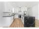 The kitchen showcases white cabinets, stainless steel appliances, black marble countertops, and a unique wood-trimmed island at 711 42Nd S Ave, St Petersburg, FL 33705