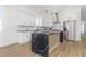 Bright kitchen features white cabinets, stainless steel appliances, black marble counters, and a decorative wood-trimmed island at 711 42Nd S Ave, St Petersburg, FL 33705