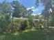 View of a single-story home obscured by lush greenery, offering a private and secluded setting at 729 41St St, Sarasota, FL 34234