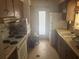 Dated kitchen with wooden cabinets, white appliances, and a view to the backyard at 729 41St St, Sarasota, FL 34234