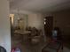 Unfurnished living room featuring dated decor, paneled walls, and natural lighting from front windows at 729 41St St, Sarasota, FL 34234