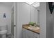 Well-lit bathroom featuring neutral fixtures, a vanity, and an enclosed shower at 7433 Greystone Dr # 7433, Hudson, FL 34667