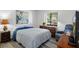 Cozy bedroom featuring a comfortable bed, natural light, and laminate wood flooring at 7433 Greystone Dr # 7433, Hudson, FL 34667