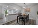Cozy dining area adjacent to kitchen, with modern lighting and laminate wood flooring at 7433 Greystone Dr # 7433, Hudson, FL 34667