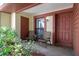 Inviting covered porch with seating area, providing a welcoming entrance to the residence at 7433 Greystone Dr # 7433, Hudson, FL 34667