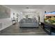Spacious living room with modern flooring, open to the dining area and kitchen at 7433 Greystone Dr # 7433, Hudson, FL 34667