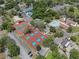 Aerial view of community tennis and pickleball courts surrounded by mature trees at 7433 Greystone Dr # 7433, Hudson, FL 34667