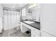 Bathroom features a shower with white curtain, gray tile floor, and vanity with white cabinets at 774 40Th Ne Ave, St Petersburg, FL 33703