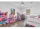 Bright bedroom featuring playful decor, two windows, and ample space for toys and activities at 774 40Th Ne Ave, St Petersburg, FL 33703