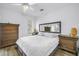 Bright bedroom with a ceiling fan, hardwood floors, and a decorative mirror above the bed at 774 40Th Ne Ave, St Petersburg, FL 33703