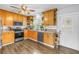Well-lit kitchen with natural wood cabinetry, stainless steel appliances, and a bright window for plants at 774 40Th Ne Ave, St Petersburg, FL 33703