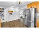Spacious kitchen with stainless steel refrigerator and views leading to a well-organized pantry and adjacent bedroom at 774 40Th Ne Ave, St Petersburg, FL 33703