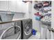 This laundry room features modern Electrolux washer and dryer and ample storage space at 774 40Th Ne Ave, St Petersburg, FL 33703