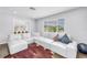 Bright and airy living room with a comfortable white sofa and access to the bright sunroom at 774 40Th Ne Ave, St Petersburg, FL 33703