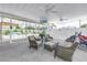 Screened patio features wicker furniture, a motorcycle, a pool and a TV for outdoor enjoyment at 774 40Th Ne Ave, St Petersburg, FL 33703