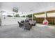 Covered patio with ceiling fans, wicker furniture, a hanging chair, and a TV for relaxation at 774 40Th Ne Ave, St Petersburg, FL 33703