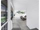 Covered patio features wicker furniture, a motorcycle, and a TV for outdoor entertainment at 774 40Th Ne Ave, St Petersburg, FL 33703