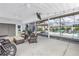 Screened patio with seating, a mounted TV, and views of the pool, perfect for relaxation at 774 40Th Ne Ave, St Petersburg, FL 33703