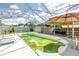 Enclosed backyard pool area featuring lounge chairs, a covered patio and mature foliage at 774 40Th Ne Ave, St Petersburg, FL 33703