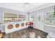 Bright sunroom featuring wood floors, decorative built-in unit, and lots of natural light at 774 40Th Ne Ave, St Petersburg, FL 33703