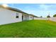 Expansive backyard with well-maintained lawn and partial view of the home's exterior at 8840 Mugnai St, Riverview, FL 33578