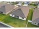 Aerial view of home's backyard, showcasing the lawn, covered patio, and perimeter fence at 8840 Mugnai St, Riverview, FL 33578
