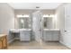 Bright bathroom featuring double vanities, tile flooring, and modern lighting fixtures at 8840 Mugnai St, Riverview, FL 33578