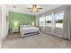 Spacious bedroom with plush carpet, neutral walls, large windows and stylish lighting at 8840 Mugnai St, Riverview, FL 33578