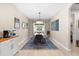 Bright dining room features a modern chandelier, blue accent rug, and a six seat dining table at 8840 Mugnai St, Riverview, FL 33578