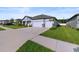 The home boasts a three-car garage and well-maintained landscaping at 8840 Mugnai St, Riverview, FL 33578