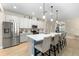 Bright kitchen features stainless steel appliances, a large center island, and pendant lighting at 8840 Mugnai St, Riverview, FL 33578