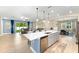 Open floor plan with kitchen island, dining area, and living room with lots of natural light at 8840 Mugnai St, Riverview, FL 33578