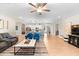 Open floor plan with living room, kitchen, and dining area, featuring a neutral color palette and hardwood floors at 8840 Mugnai St, Riverview, FL 33578