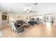 Open floor plan with living room, kitchen, and dining area, featuring a neutral color palette and hardwood floors at 8840 Mugnai St, Riverview, FL 33578