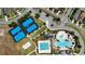 Aerial view of the community's recreational facilities featuring pools, tennis courts, and parking at 8922 Little Bluestem Dr, Land O Lakes, FL 34637