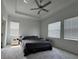 Bright and airy bedroom with a ceiling fan and carpeted floors at 8922 Little Bluestem Dr, Land O Lakes, FL 34637