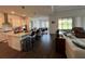 A stylish kitchen features an island with bar stools, stainless steel appliances, and views of the living room at 8922 Little Bluestem Dr, Land O Lakes, FL 34637