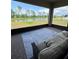 Relaxing screened-in patio with comfortable seating and a scenic view of the pond at 8922 Little Bluestem Dr, Land O Lakes, FL 34637