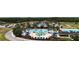 Stunning aerial view of the community pool, clubhouse, and surrounding landscape at 8922 Little Bluestem Dr, Land O Lakes, FL 34637