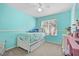This bedroom features a single bed, a ceiling fan, and light-blue painted walls at 9206 River Rock Ln, Riverview, FL 33578