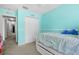 Bright bedroom featuring a single bed, closet, and light-blue walls at 9206 River Rock Ln, Riverview, FL 33578