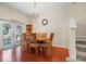 Cozy dining area with modern chandelier, wood floors, and outdoor access at 9206 River Rock Ln, Riverview, FL 33578