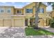 Charming townhome featuring colorful shutters, a well-manicured lawn and a paver driveway and walkway at 9206 River Rock Ln, Riverview, FL 33578