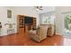 Comfortable living room with built-in shelving, hardwood floors, and lots of natural light at 9206 River Rock Ln, Riverview, FL 33578
