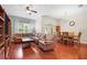 Open-concept living and dining area featuring hardwood floors, modern lighting and comfortable seating at 9206 River Rock Ln, Riverview, FL 33578