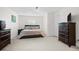 Main bedroom showcasing neutral carpet, a modern bed frame, and dark wood furniture at 9206 River Rock Ln, Riverview, FL 33578