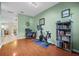 Bright home office with cherry wood floors, pale green walls, and natural light at 9206 River Rock Ln, Riverview, FL 33578